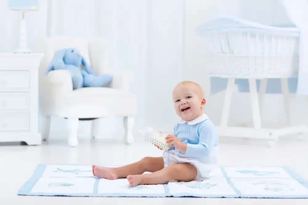 baby playing with his bottles instead drinking