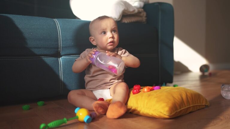baby chewing on bottle nipple instead of drinking