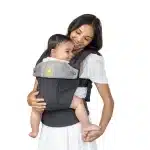 mother holding her baby in baby carrier