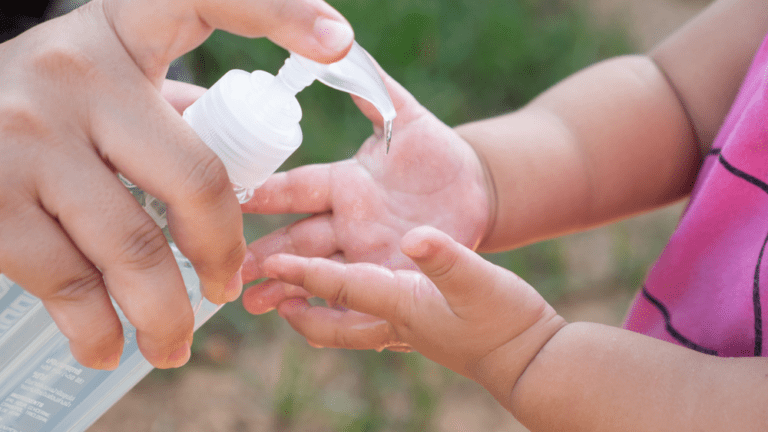 baby using hand sanetizer